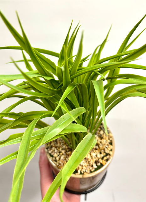 Faux grass with decorative planter