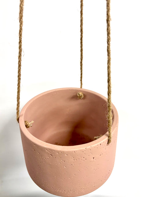 Pink hanging concrete planter