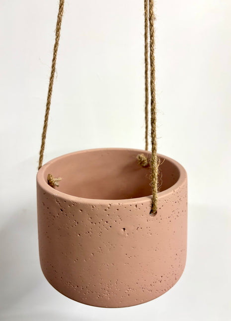 Pink hanging concrete planter